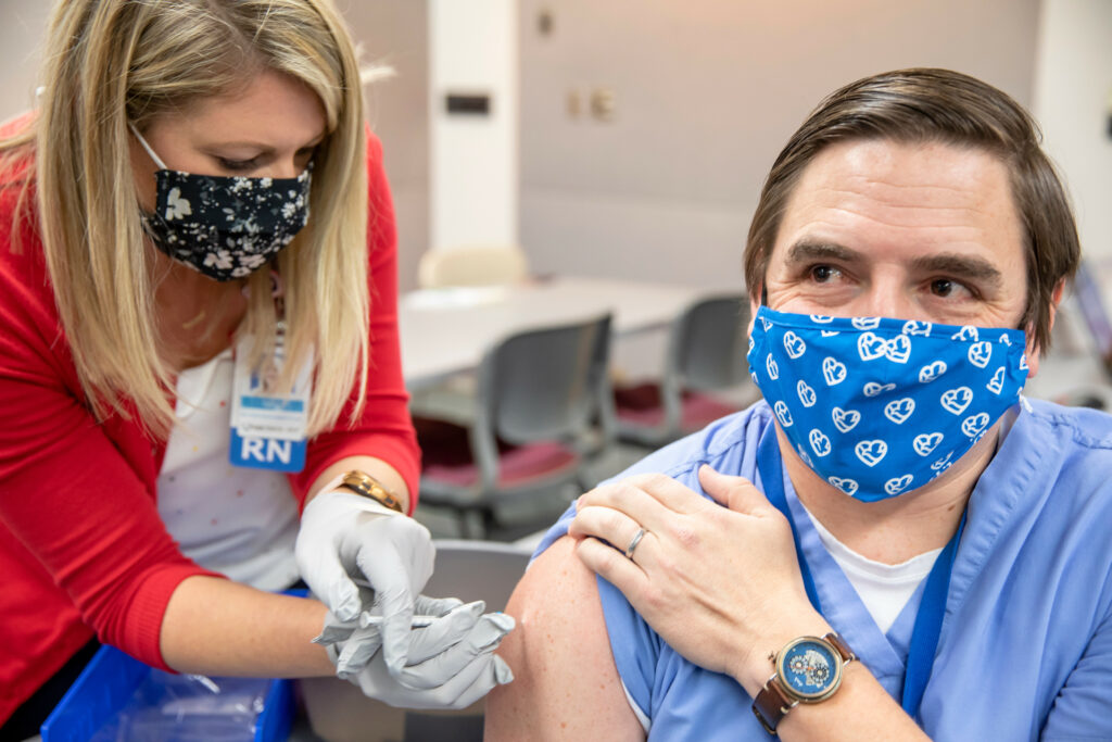 methodist employee giving a vaccination