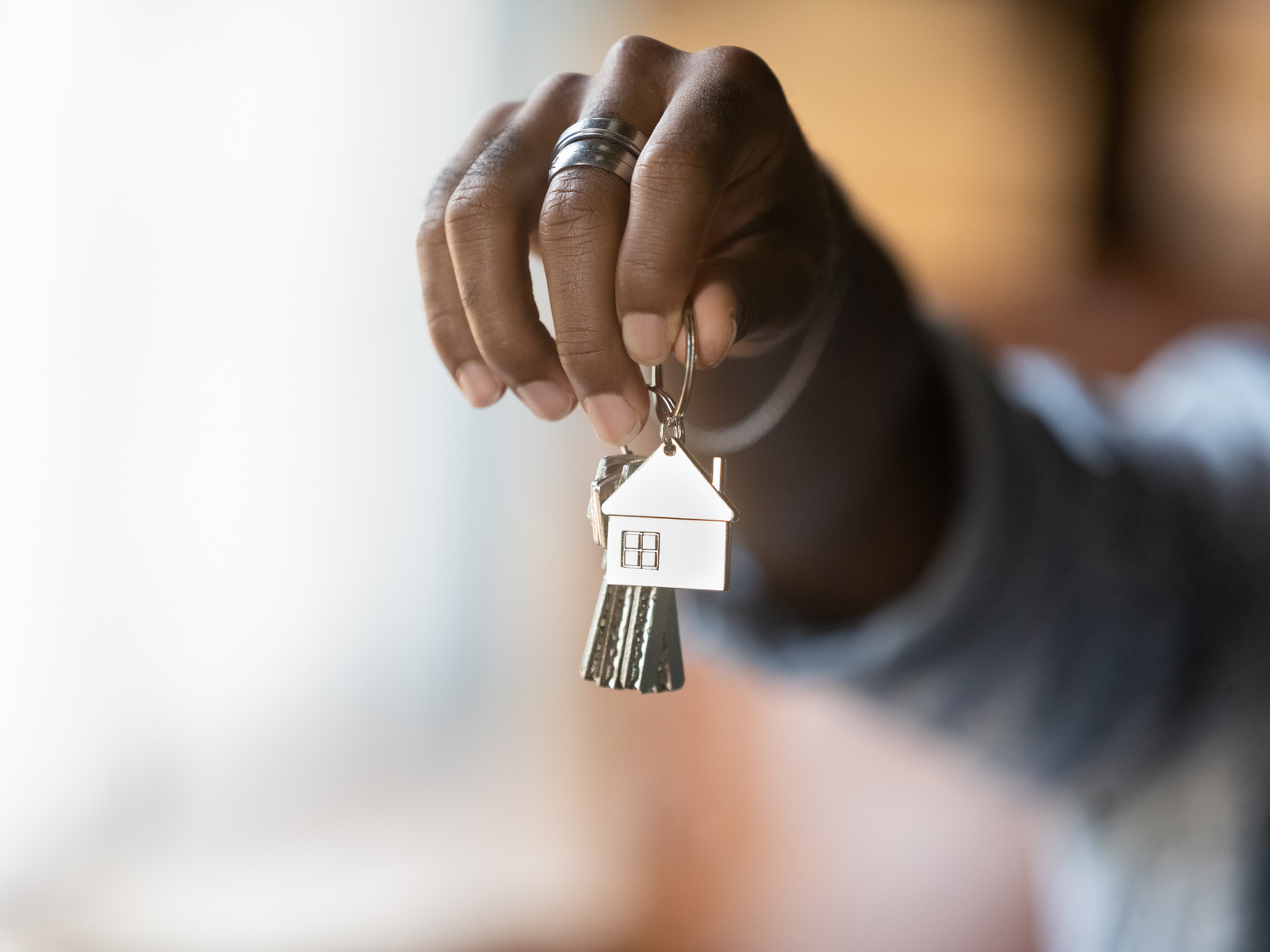 homeowner close up of a man's hand holding house keys