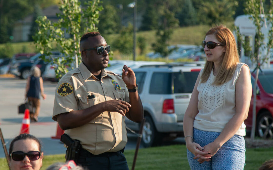 An Elite Tactical security guard chats with a member of the community at an event.