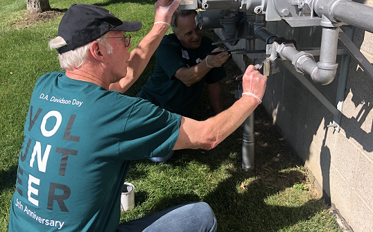 DA Davidson employee volunteering to help paint a home