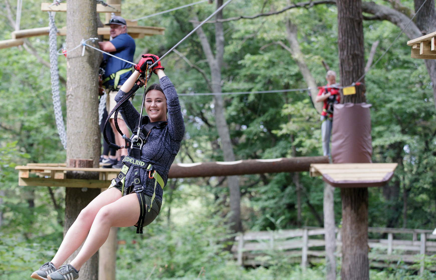 Woman riding a zip line at Fontenelle Forest Tree Rush.
