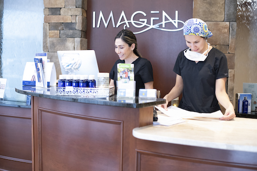 Members of the Imagen Body Sculpting team working the welcome desk.